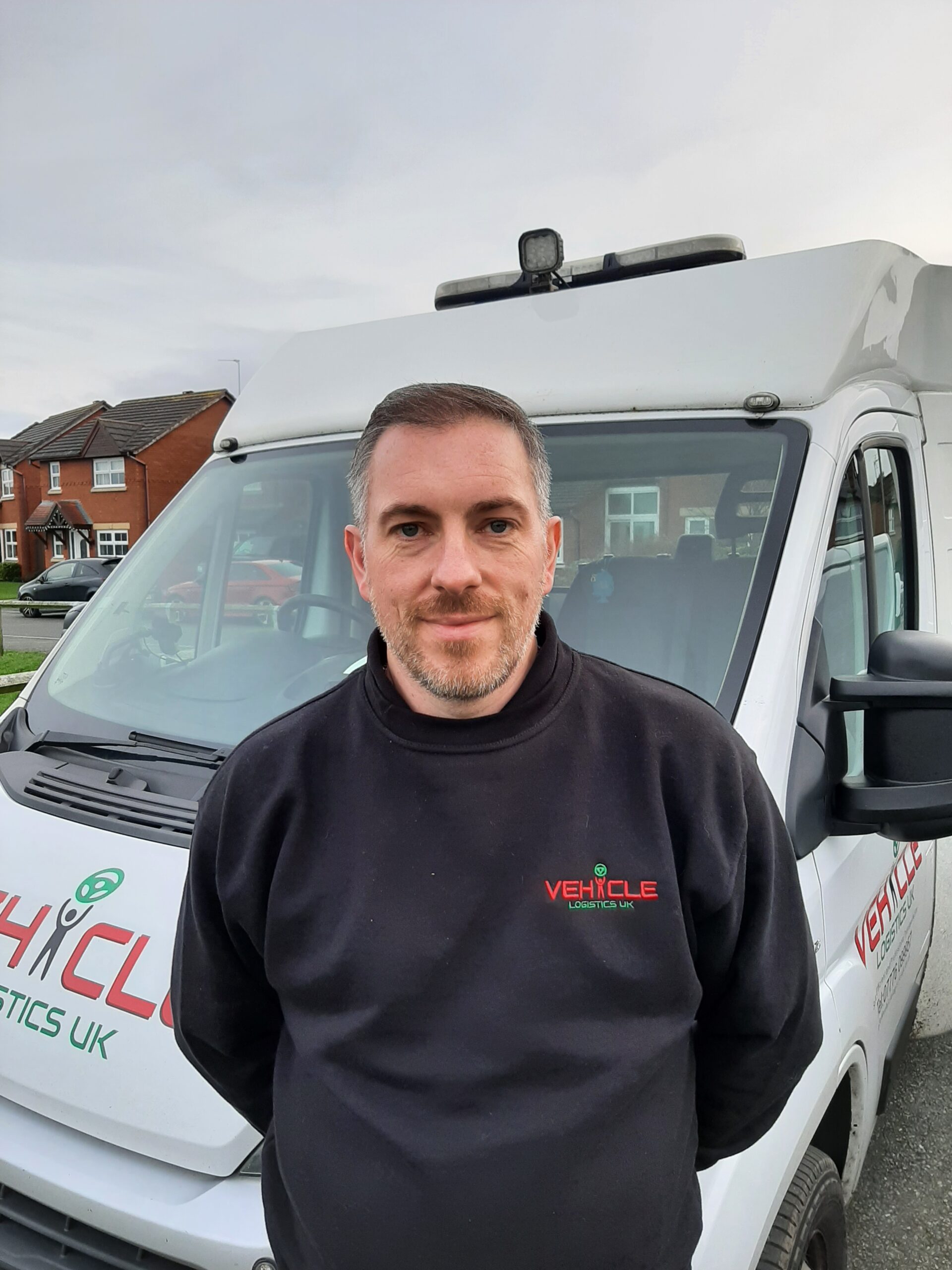 Simon beside a vehicle from his earlier Vehicle Logistics UK business.